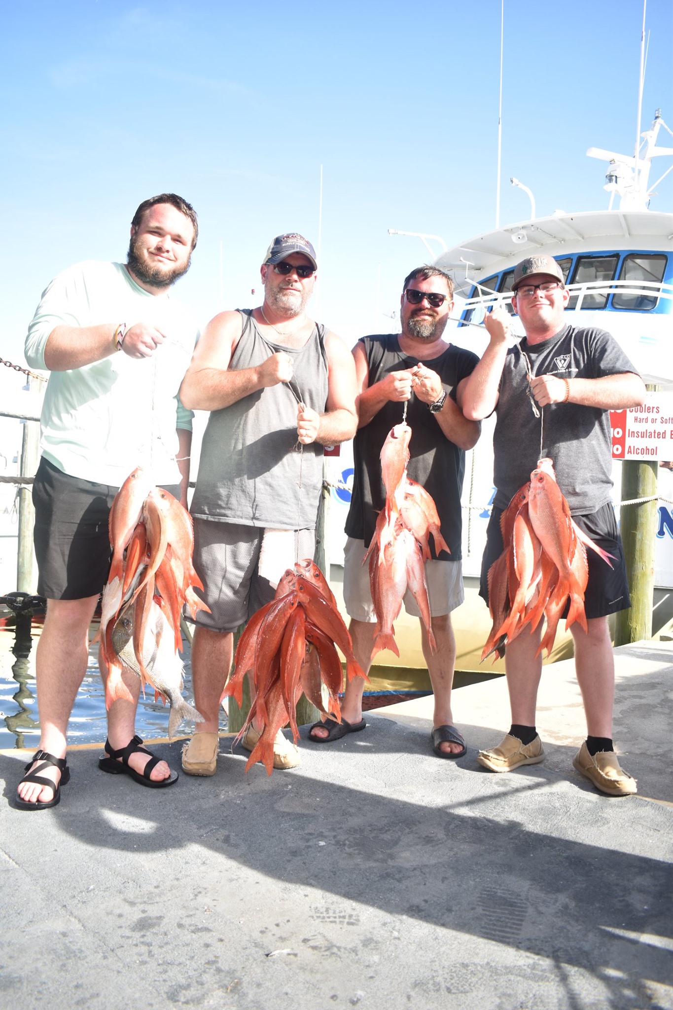Captain Anderson's Marina 5-hour deep sea fishing tours in Panama City Florida, fishermen holding fresh catch of the day